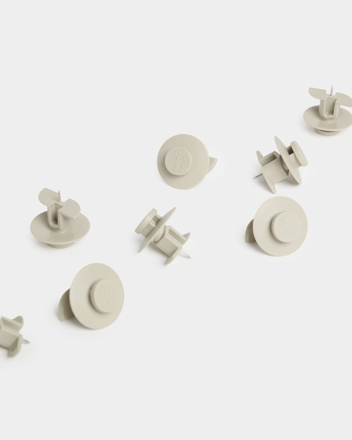 Ten beige Dupps arranged on a white surface
