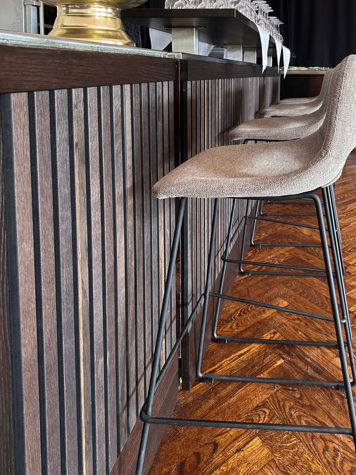 Akupanel acoustic slat panels in Rustic Smoked Oak on a restaurant bar