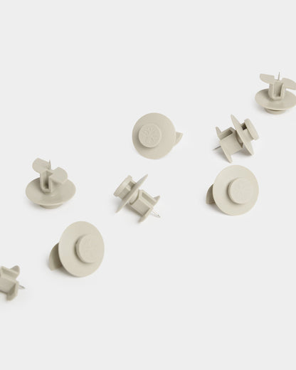 Ten beige Dupps arranged on a white surface